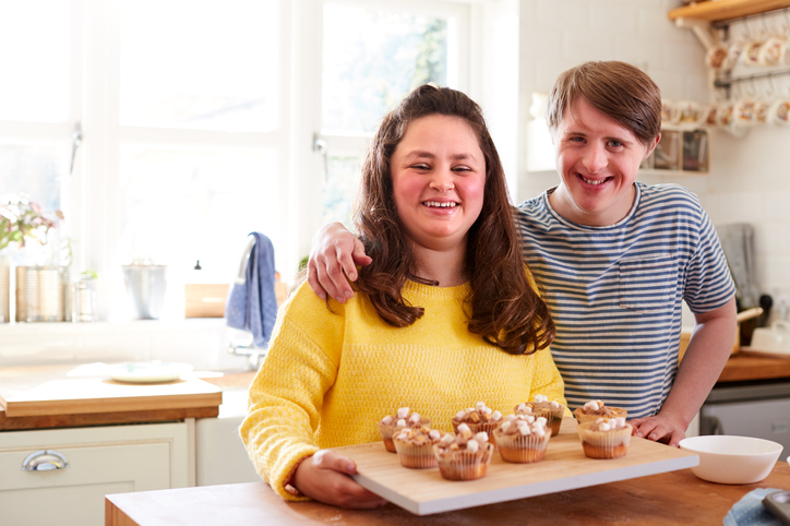 Woman with Down Syndrome Baking In Kitchen At Home